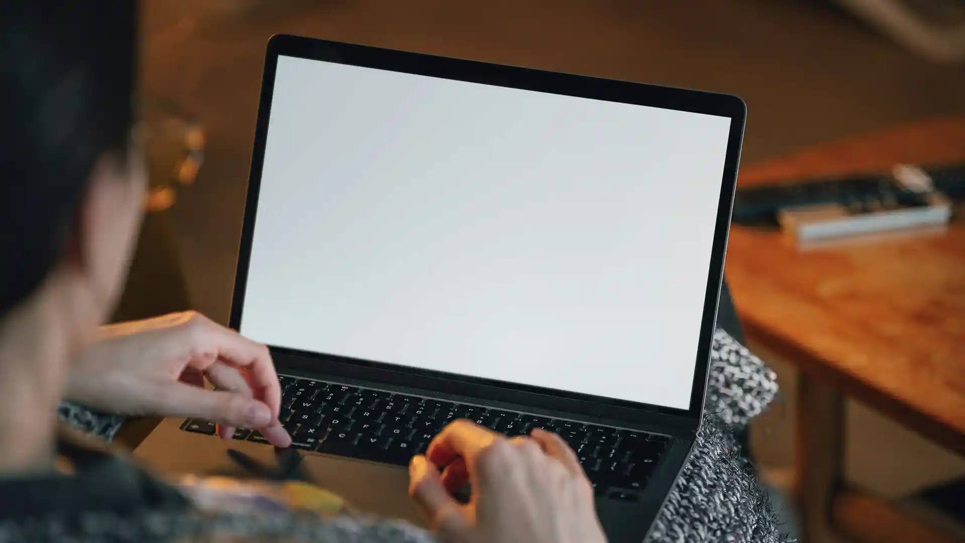 Female person with a laptop on her lap.